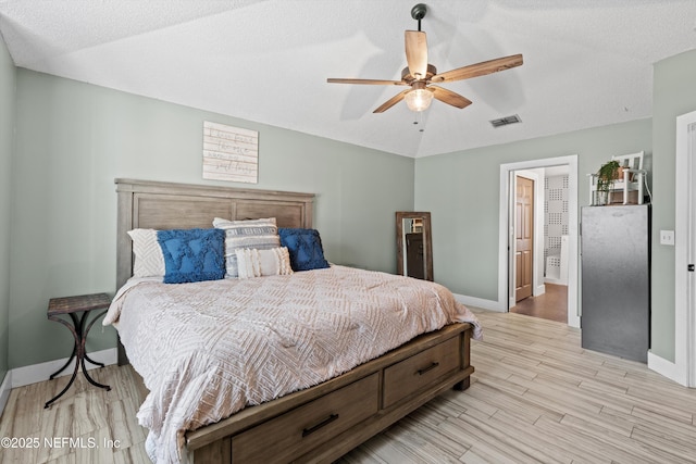 bedroom with lofted ceiling, light hardwood / wood-style floors, and ceiling fan