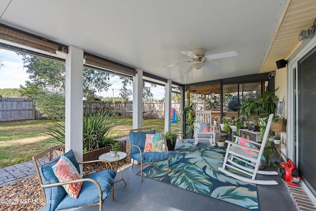 sunroom featuring ceiling fan