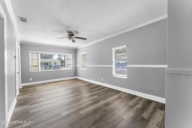 spare room with ornamental molding, dark hardwood / wood-style floors, and ceiling fan