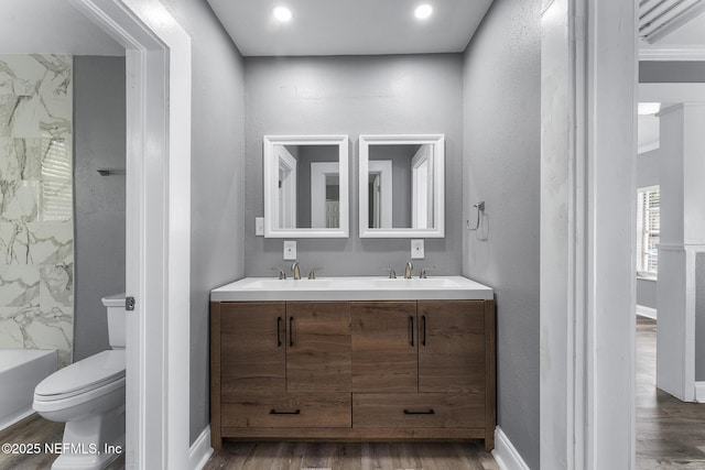 bathroom featuring wood-type flooring, vanity, and toilet