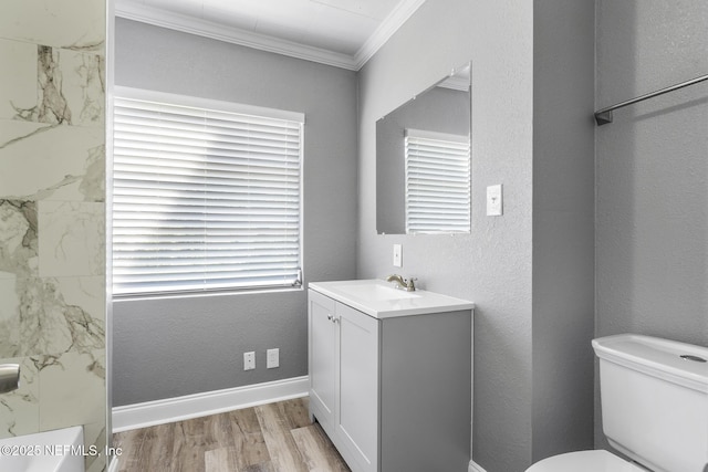 bathroom featuring ornamental molding, vanity, toilet, and hardwood / wood-style floors