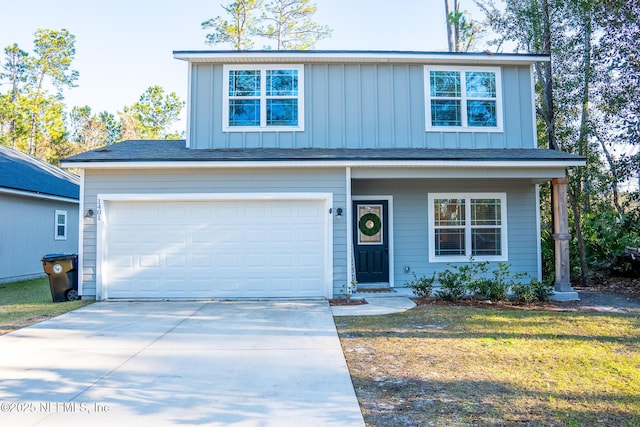 view of front of property with a garage and a front lawn