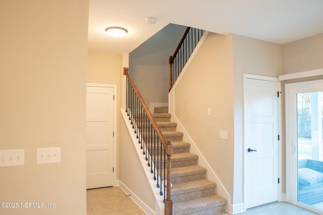 stairs with tile patterned flooring