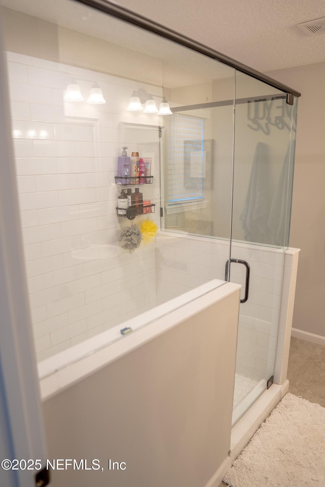 bathroom with a shower with shower door