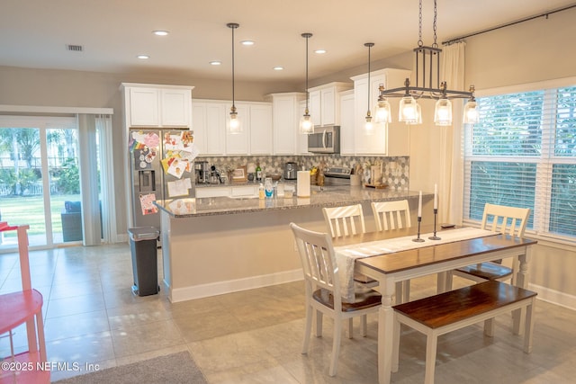 dining space with light tile patterned floors