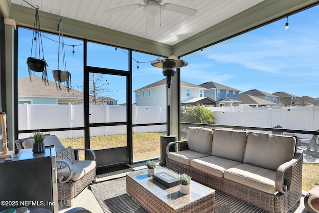 sunroom featuring ceiling fan