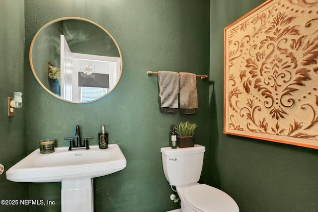 bathroom featuring sink and toilet