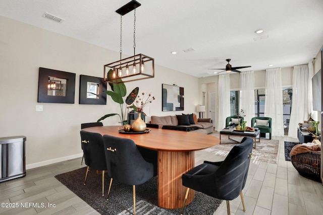 dining area with hardwood / wood-style floors and ceiling fan