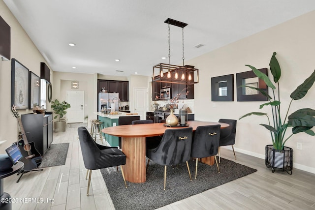 dining space featuring light hardwood / wood-style floors