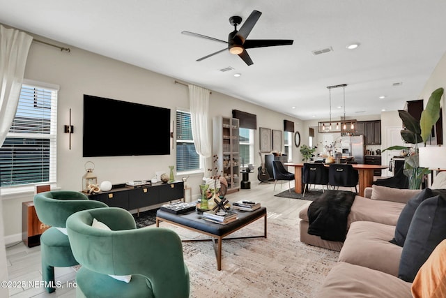 living room with ceiling fan and light hardwood / wood-style floors