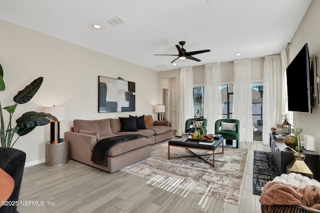 living room featuring light hardwood / wood-style floors and ceiling fan