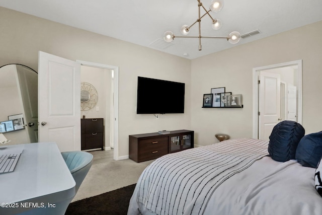 bedroom featuring a chandelier, light colored carpet, and ensuite bath