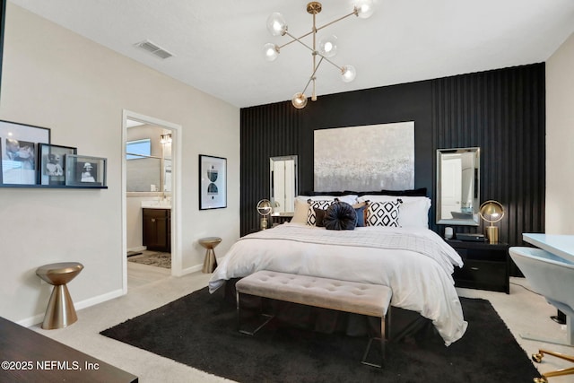 bedroom featuring light colored carpet, connected bathroom, and a notable chandelier