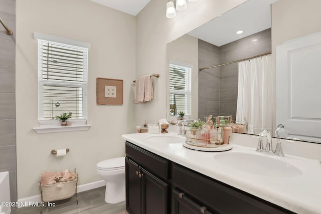 bathroom featuring walk in shower, vanity, and toilet