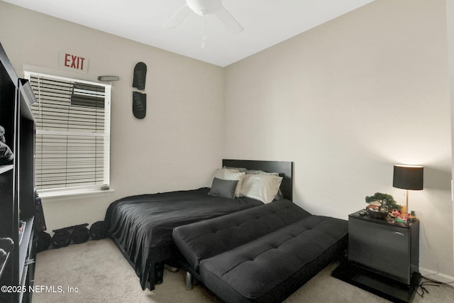 bedroom featuring light colored carpet and ceiling fan