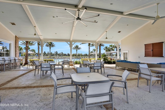 view of patio / terrace featuring a water view and ceiling fan