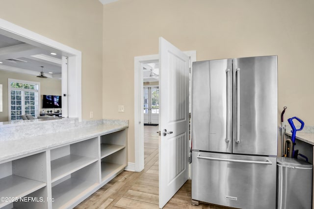 kitchen featuring ceiling fan, plenty of natural light, high end fridge, and light hardwood / wood-style floors