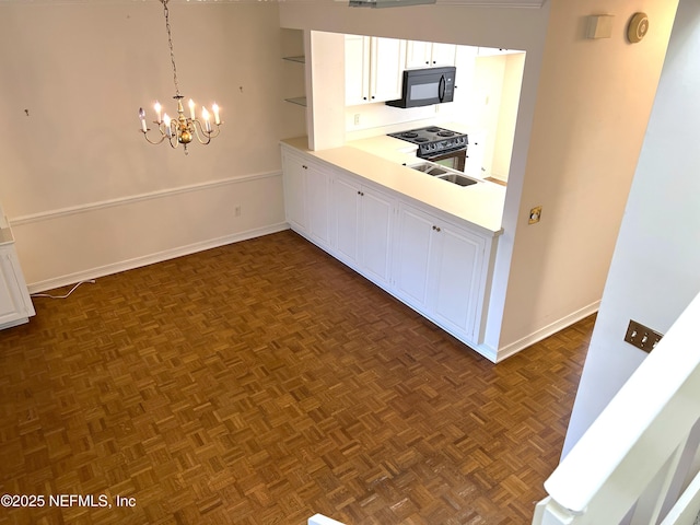 kitchen with a notable chandelier, hanging light fixtures, white cabinets, and electric stove