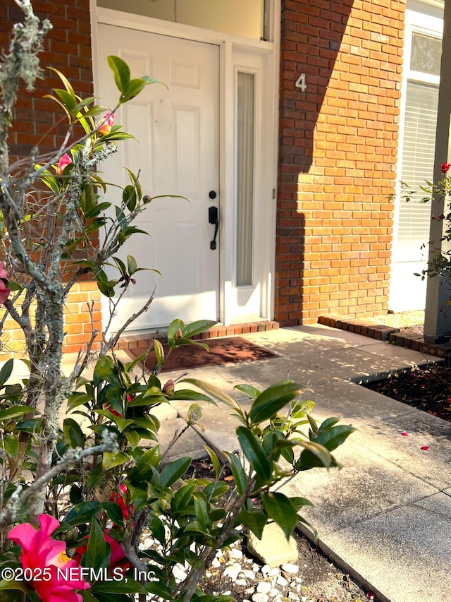 entrance to property featuring a patio