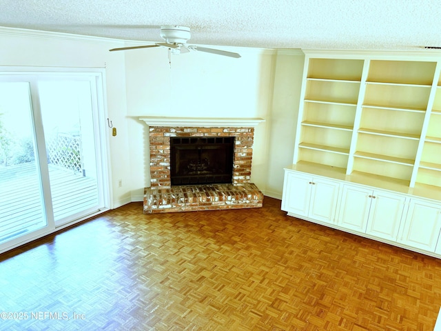 unfurnished living room featuring ceiling fan, parquet flooring, a fireplace, and a textured ceiling