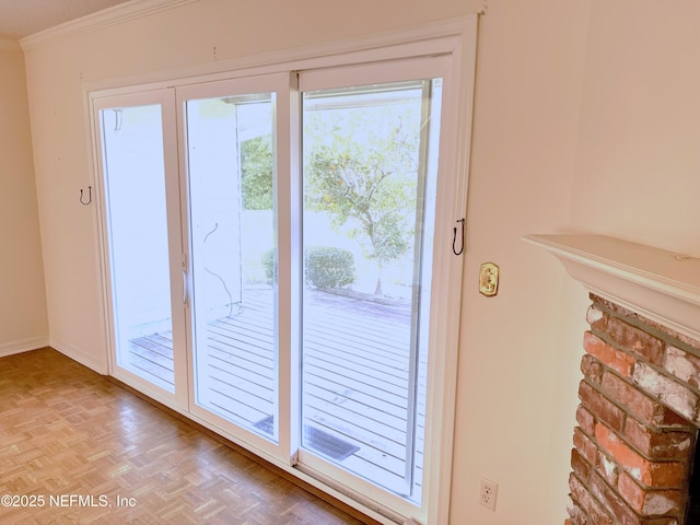 doorway featuring crown molding and light parquet floors