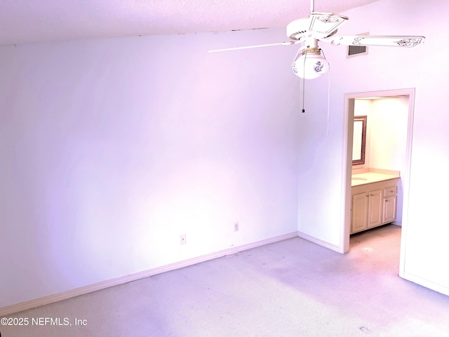 empty room featuring light carpet and ceiling fan