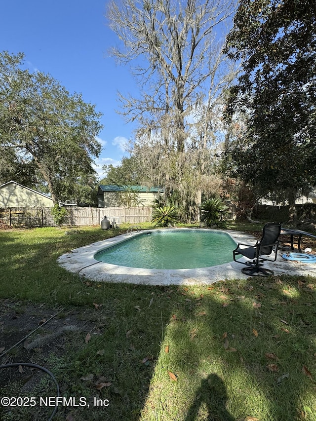 view of pool with a yard and a patio