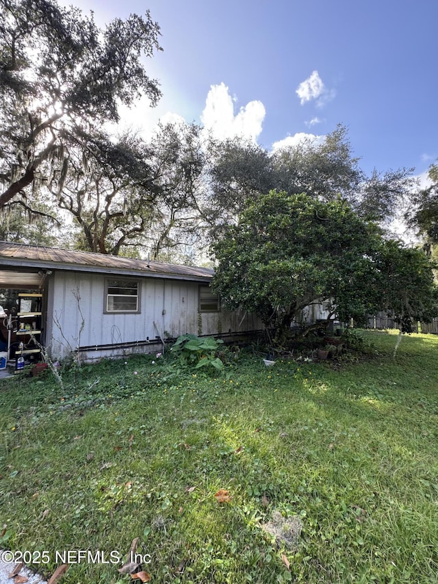 view of side of property featuring a yard