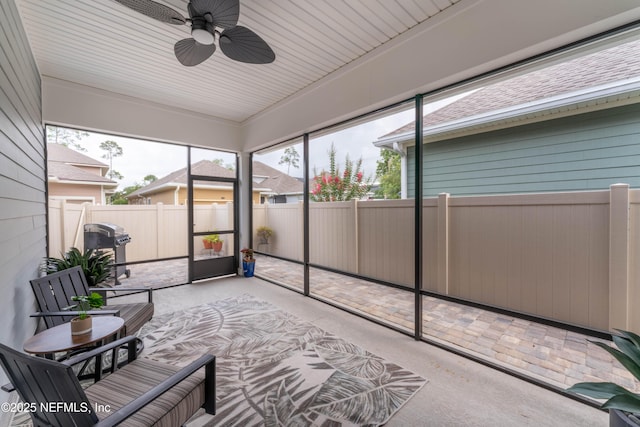 sunroom featuring ceiling fan