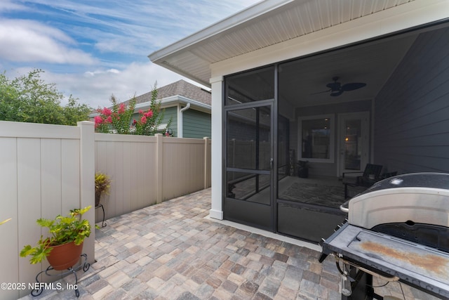 view of patio / terrace featuring a sunroom, area for grilling, and ceiling fan