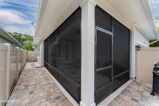 view of home's exterior featuring ceiling fan, a patio, and a sunroom