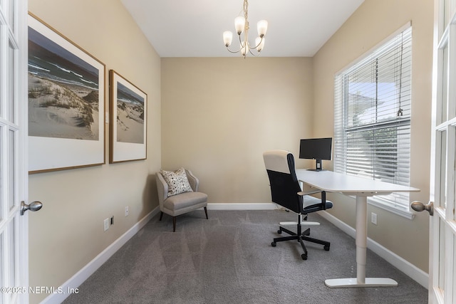 office space with a chandelier and dark carpet