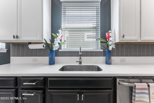 kitchen with dishwasher, plenty of natural light, sink, and white cabinets