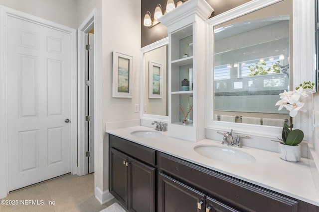 bathroom with tile patterned flooring, vanity, and walk in shower