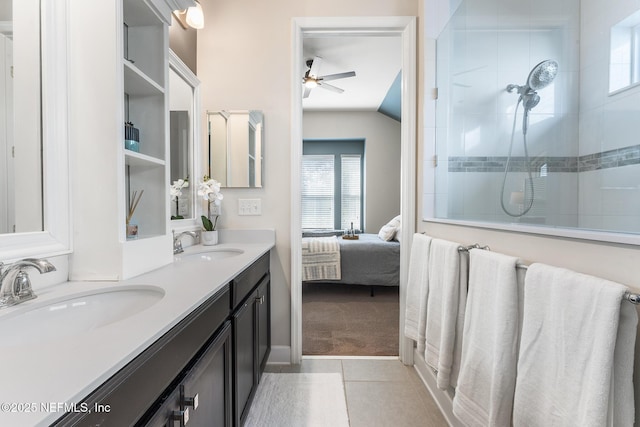 bathroom featuring lofted ceiling, a tile shower, vanity, ceiling fan, and tile patterned flooring