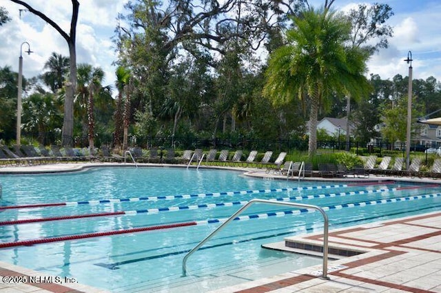 view of swimming pool with a patio