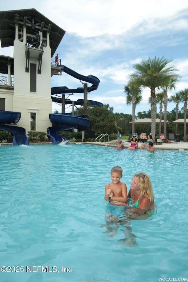 view of pool with a water slide