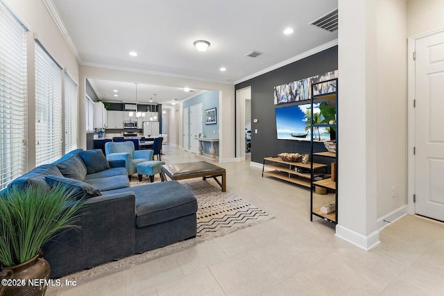 living room with ornamental molding and light tile patterned floors