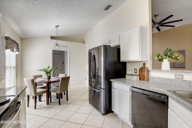 kitchen featuring light tile patterned floors, hanging light fixtures, stainless steel appliances, white cabinets, and vaulted ceiling