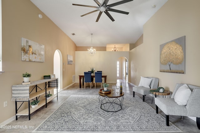 living room featuring ceiling fan with notable chandelier and high vaulted ceiling