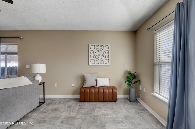 living area featuring a textured ceiling