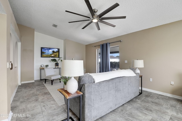 living room with vaulted ceiling, a textured ceiling, and ceiling fan