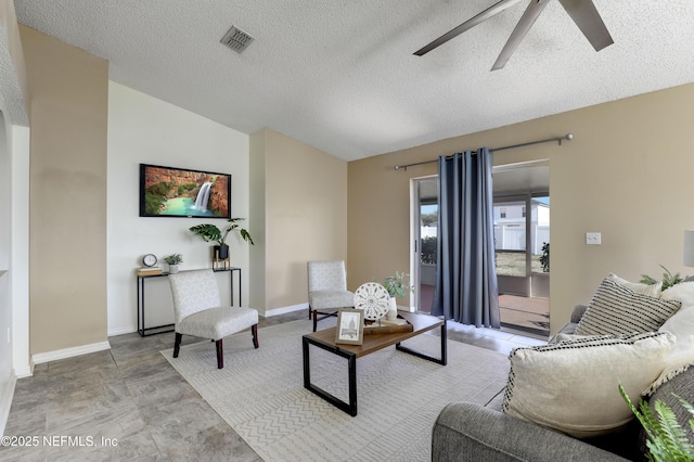 living room with vaulted ceiling, a textured ceiling, and ceiling fan