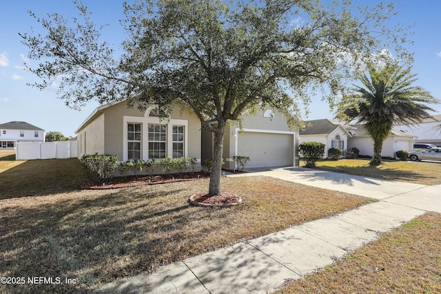 view of front of home featuring a garage and a front lawn