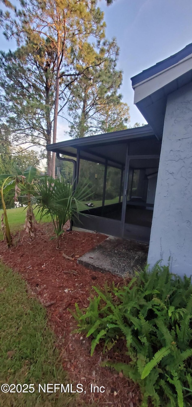 view of yard featuring a sunroom