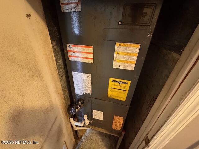 utility room featuring heating unit