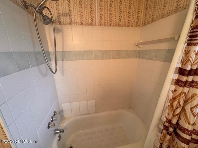 bathroom with shower / bath combo with shower curtain