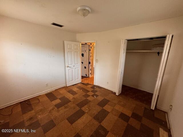 unfurnished bedroom with a closet