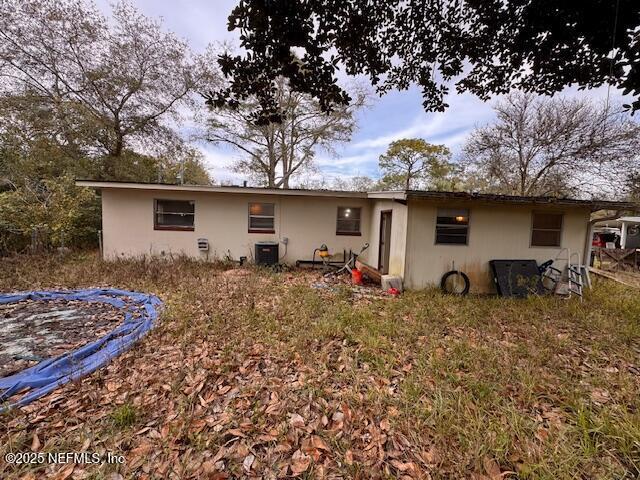 back of property featuring central AC unit