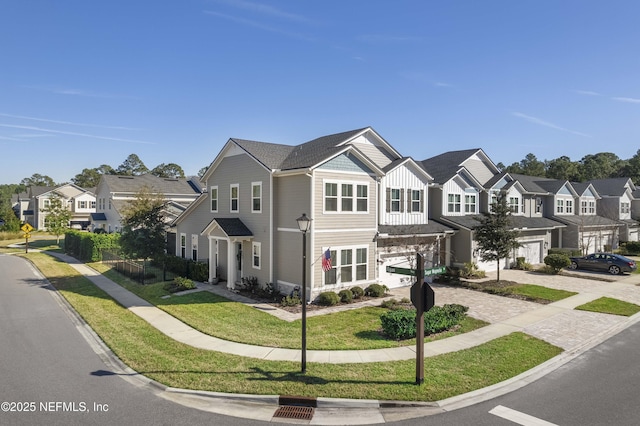 multi unit property with a garage and a front lawn